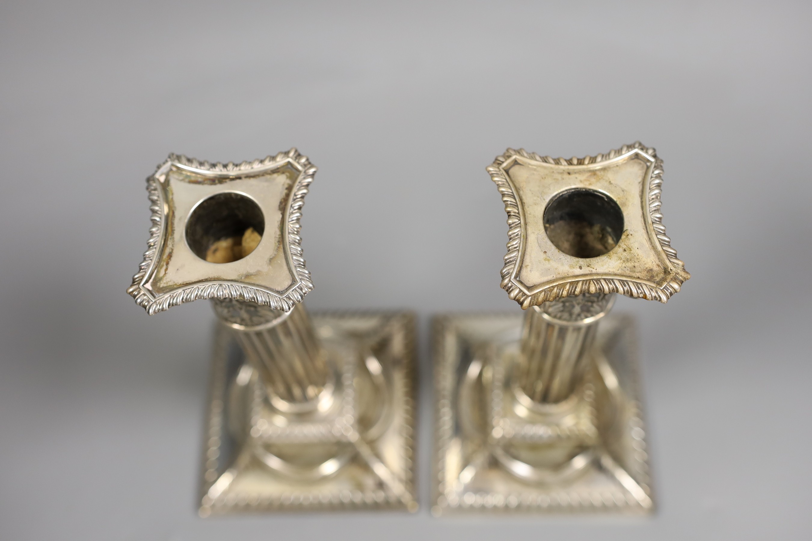 A pair of Edwardian silver Corinthian column candlesticks, Henry Wigful, Sheffield, 1904, height 19.7cm, weighted.